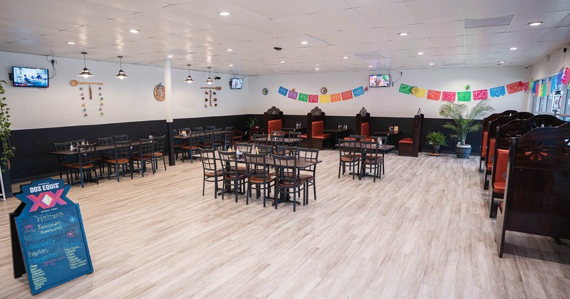 Interior, seating area with tables, chairs and restaurant booths