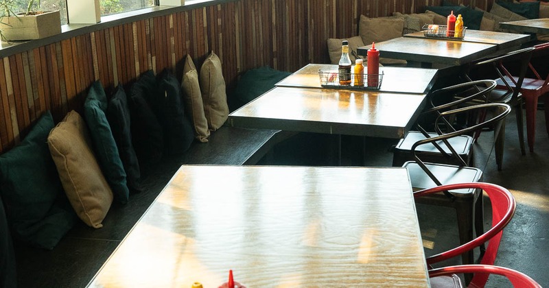 Interior, tables, chairs and bench in dining area