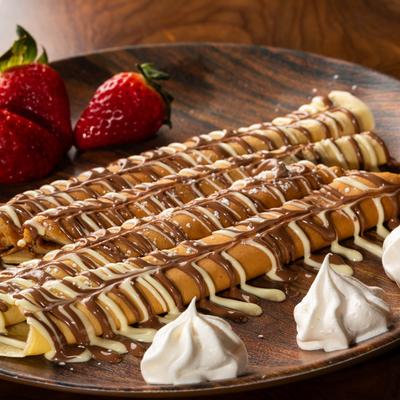 Nutella, chocolate drizzle, powdered sugar, and whipped cream.