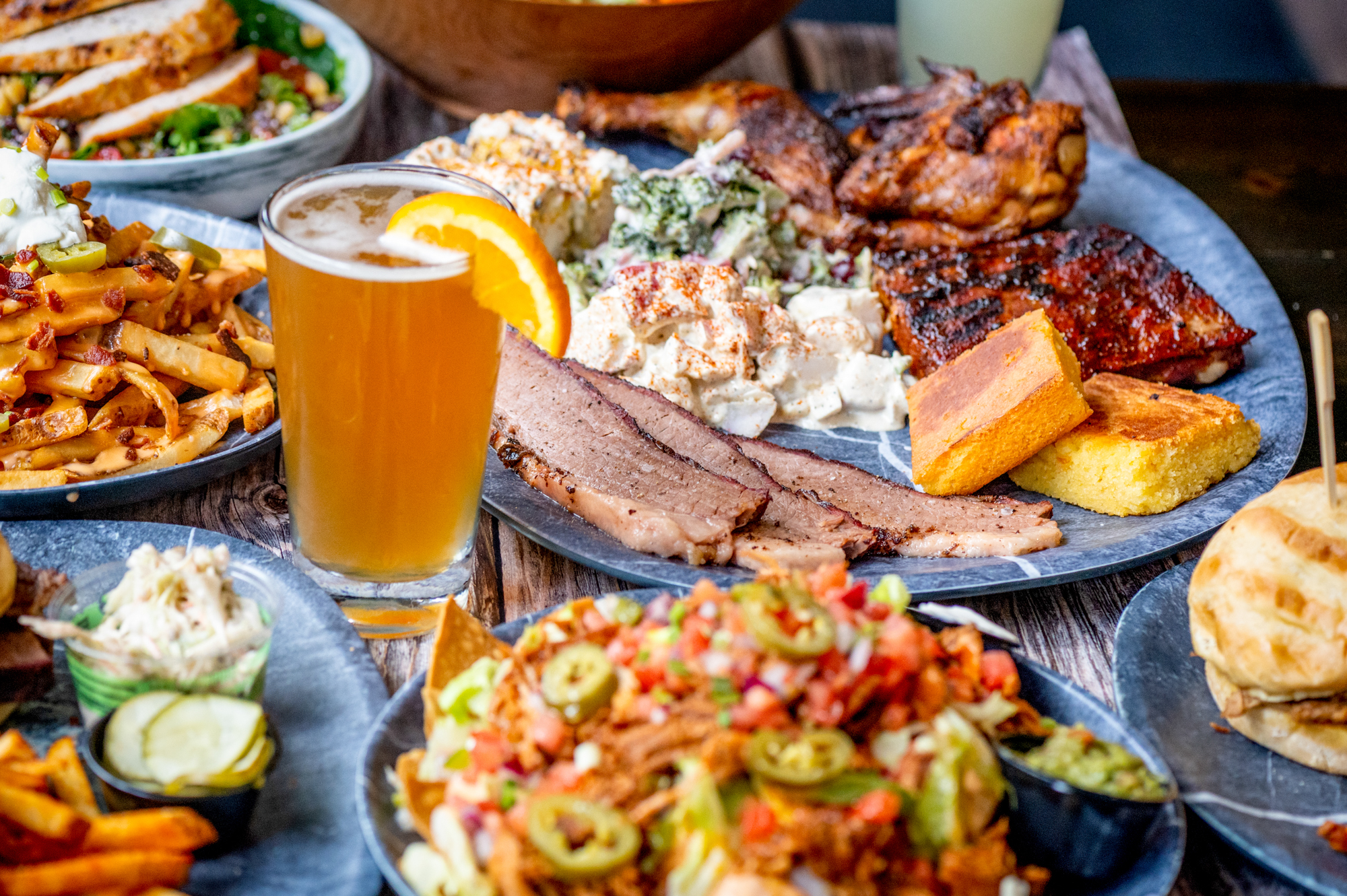 Barbecue platter with loaded nachos and a beer on a table