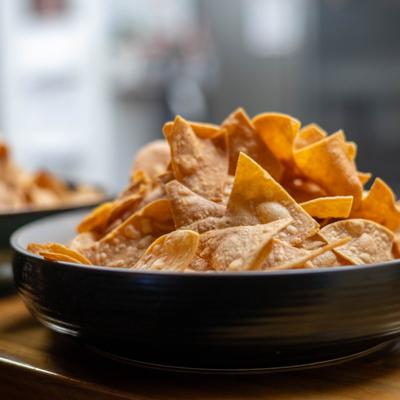 Fried corn tortilla chips served in a bowl.