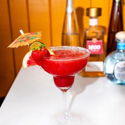 A served drink and bottles.