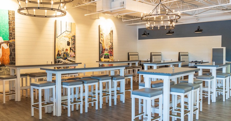 Interior, high seating area with bar tables and bar stools