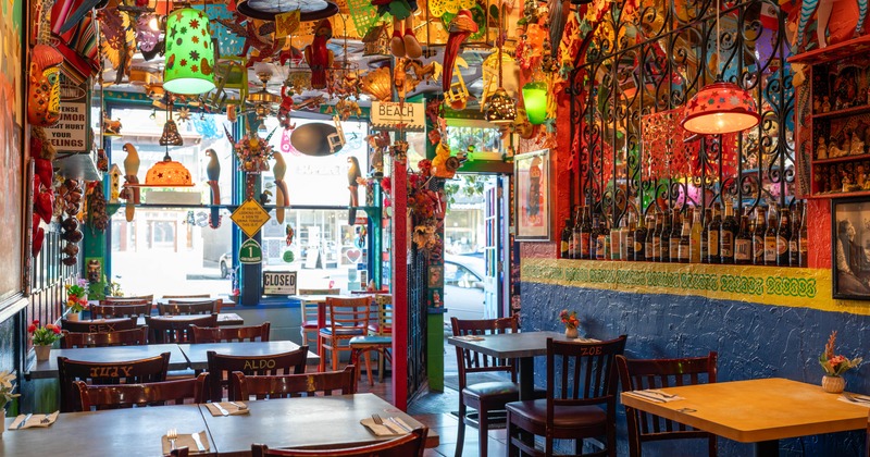 Colorful restaurant interior with vibrant decorations hanging from the ceiling
