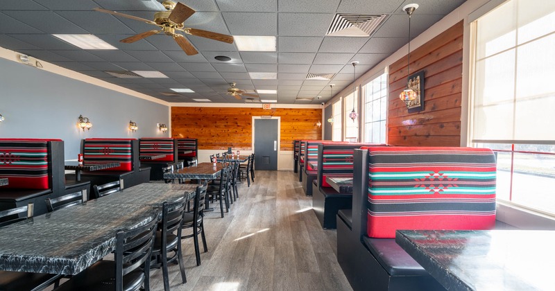 Interior dining area with double booths, chairs and tables
