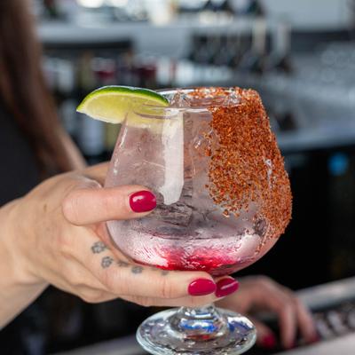 Hand holding a cocktail.