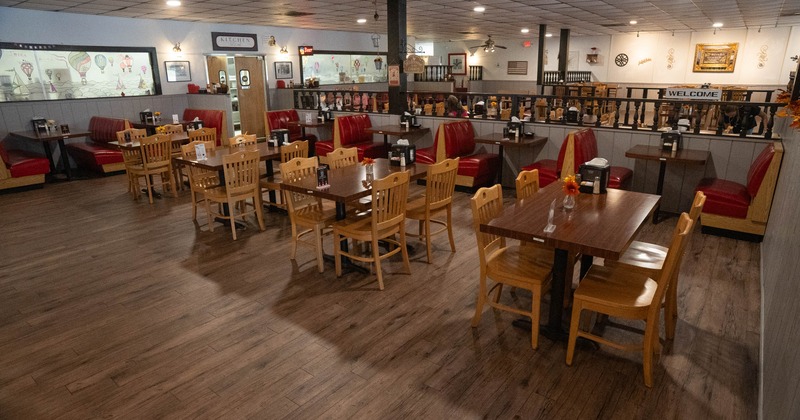 Restaurant interior with wooden tables and red booth seats