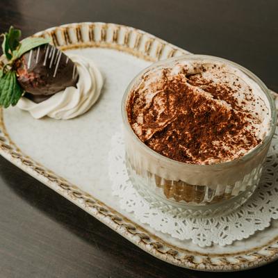 Tiramisu dusted with dark chocolate shavings.