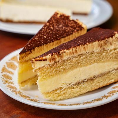 Two slices of tiramisu  cake on a plate.