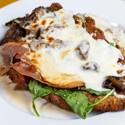 Breaded chicken breast with prosciutto, mushrooms, spinach topped with mozzarella.