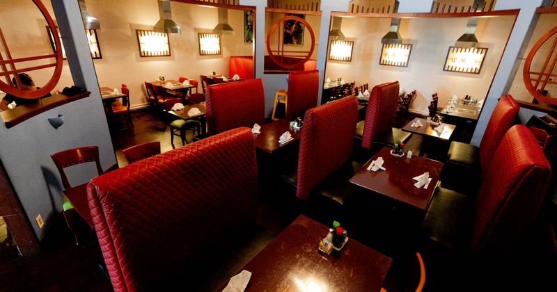 Interior, red leather padded seating booths with tables, chairs and tables ready for guests