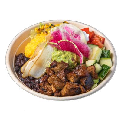 Pork bowl featuring rice, beans, guacamole, corn and fresh vegetables.