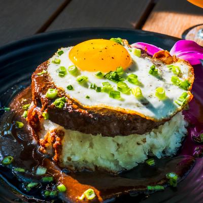 Beef patty served over sushi rice, with fried egg and steak sauce.