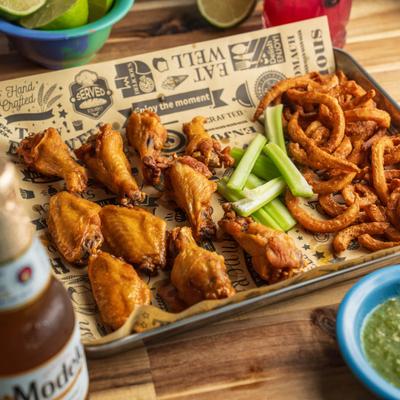 Traditional Wings served with curly fries, celery sticks and a green dipping sauce.