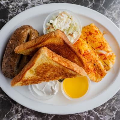 Baked haddock served with a baked potato, garlic toast, coleslaw, and two dipping sauces.