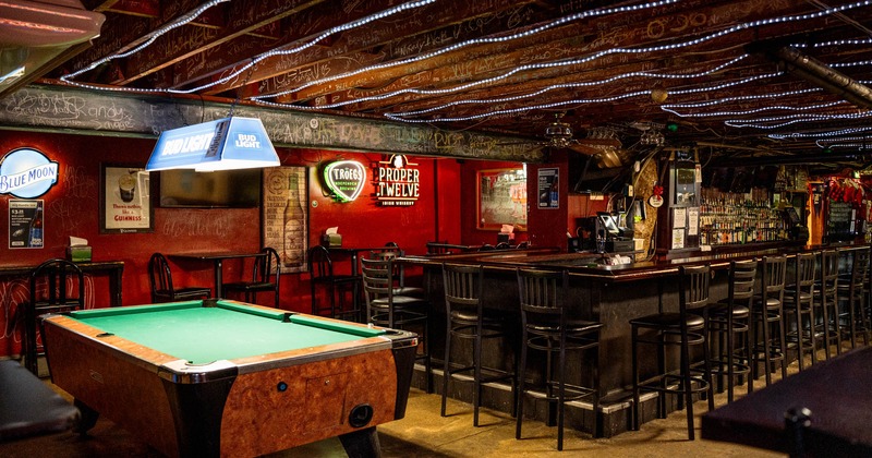 Interior, downstairs seating area, bar with stools, high tables, billiards table