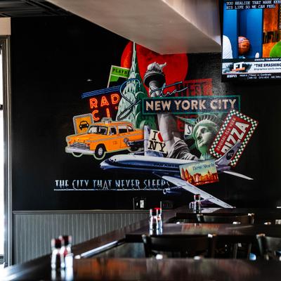 Mural with a New York City theme covering restauran's wall.