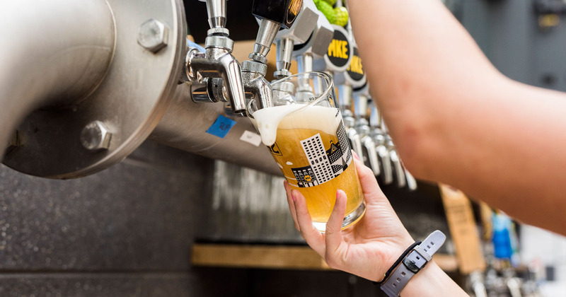 Staff member pouring beer from the tap