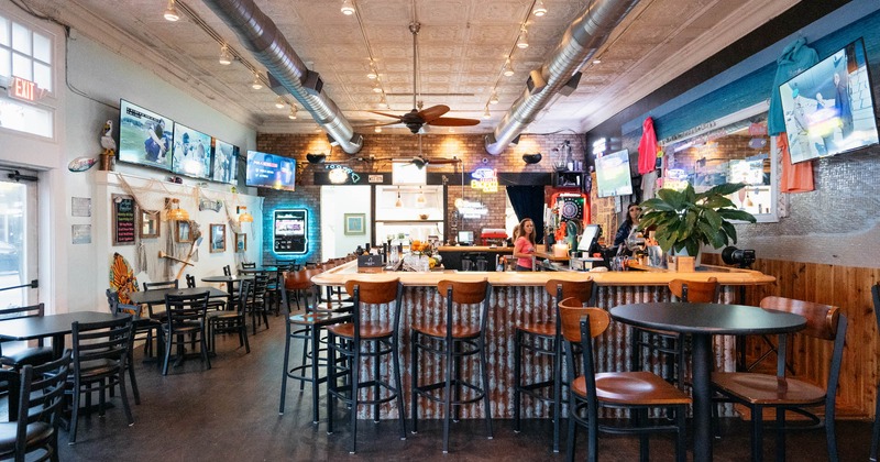 Interior, vide view, bar and chairs, diner tables