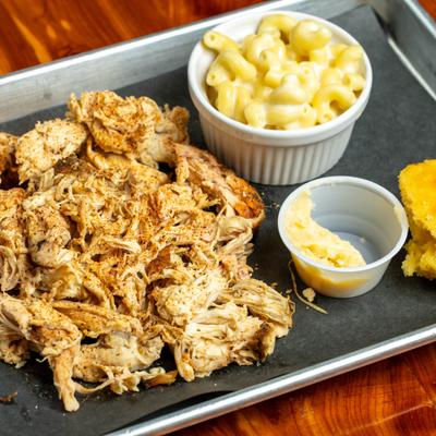 Pulled chicken entree with a side of mac and cheese.