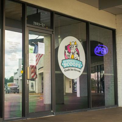 Storefront with glass door entrance and signage.