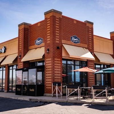 Exterior with signage and outdoor seating.