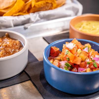 Chips and red, green, and pico salsa.