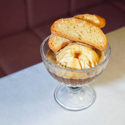 Ice cream with biscotti in a glass dessert cup.