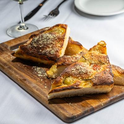 Baked Focaccia bread, with tomato, rosemary, and garlic.