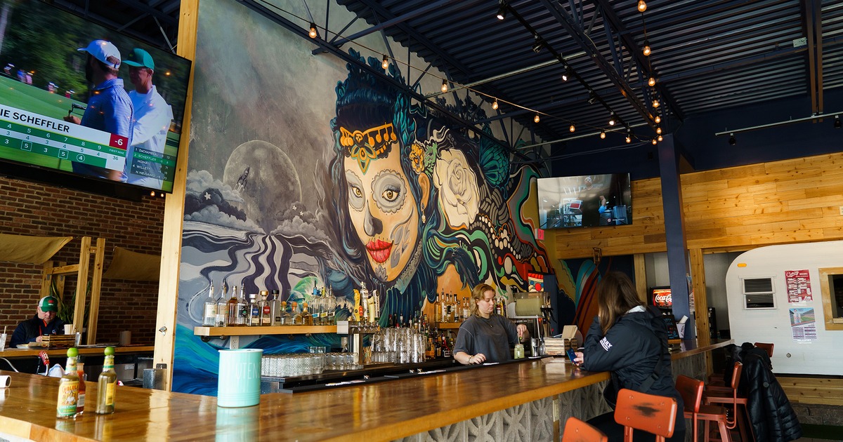 A bar with a large mural art