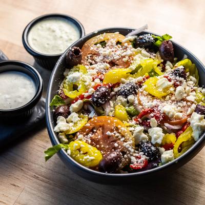 Chopped Greek Salad topped with crumbled feta and served with two sauces.