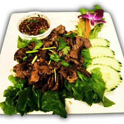 Grilled steak served with Thai spicy sauce.