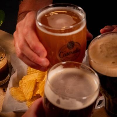 Three people toasting with beer.