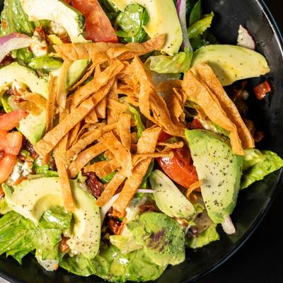 Avocado salad with tortilla strips.