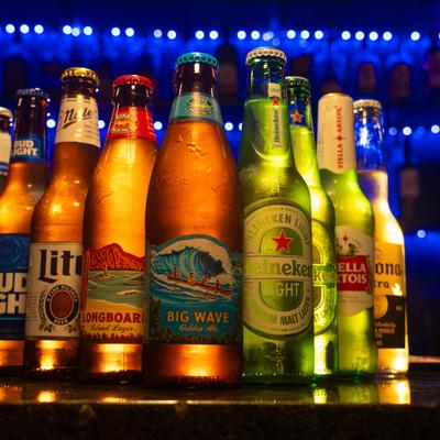 Assorted beers with a blue-lit bar background.