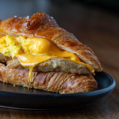 Spicy bacon, egg, cheese, sausage sandwich, closeup.