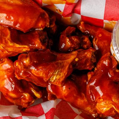 Chicken wings covered in sauce.