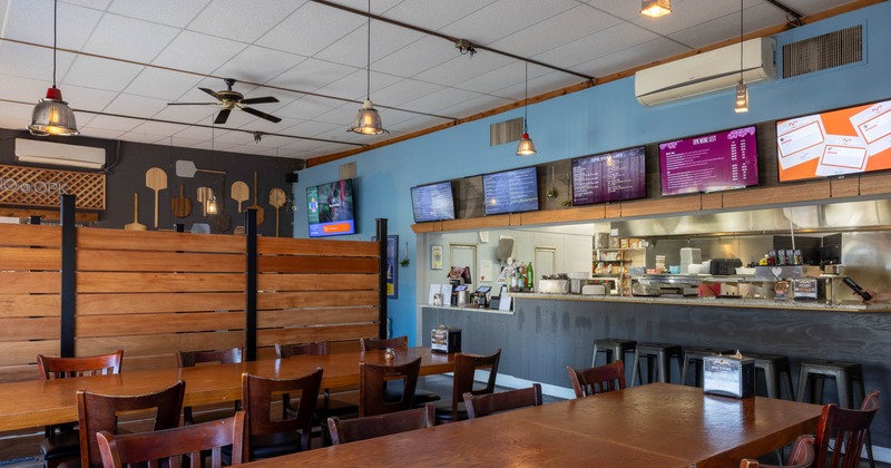 Interior, dining area, long table setups on the left, checkout counter on the right