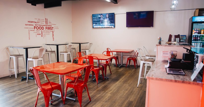 Dining area with TV on the wall and a bar on the right side