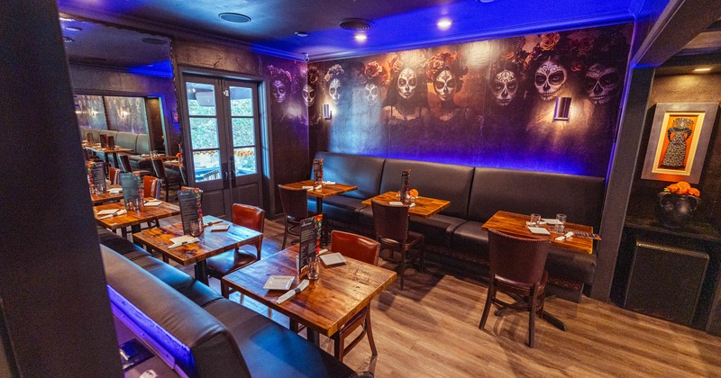 Interior of an artistic restaurant, wooden tables, and bench seating