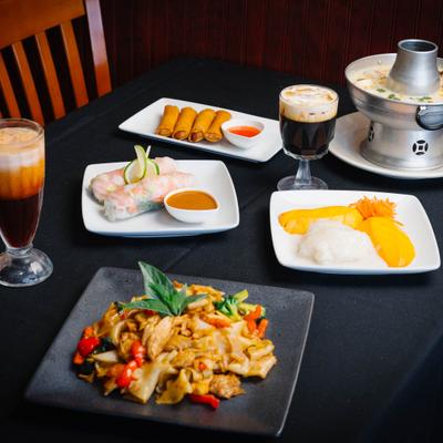 Thai dishes and coffee drinks served across the table.