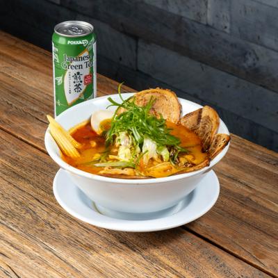 Spicy Miso Ramen with stir-fried veggies, baby corn, a half egg, and spicy pork belly.