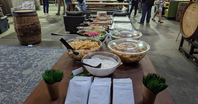 Open table with serving containers filled with food