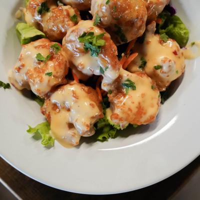 Back Nine Shrimp served over lettuce with creamy sauce.
