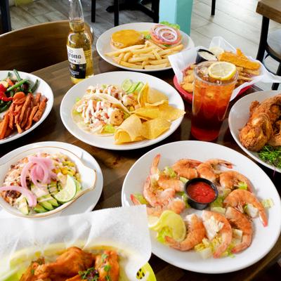 Assortment of dishes spread on a table with drinks.