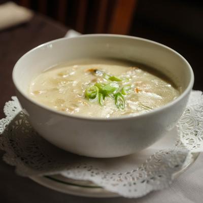 Homemade Chowder decorated with sliced green onions.
