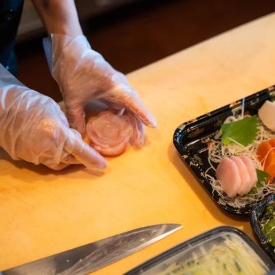 Hands preparing food.