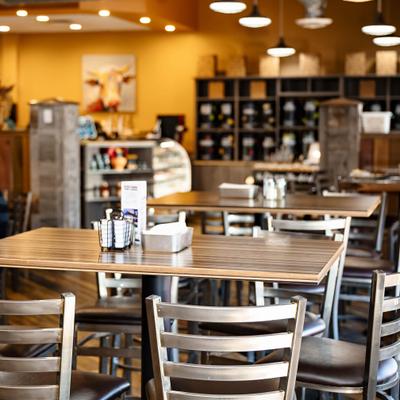 Cafe dining area with wooden tables.