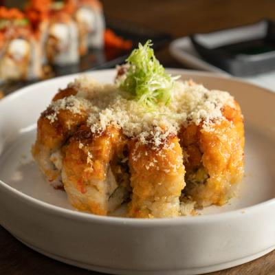 Blaze Roll topped with a savory sauce, tempura flakes, and green onion garnish.