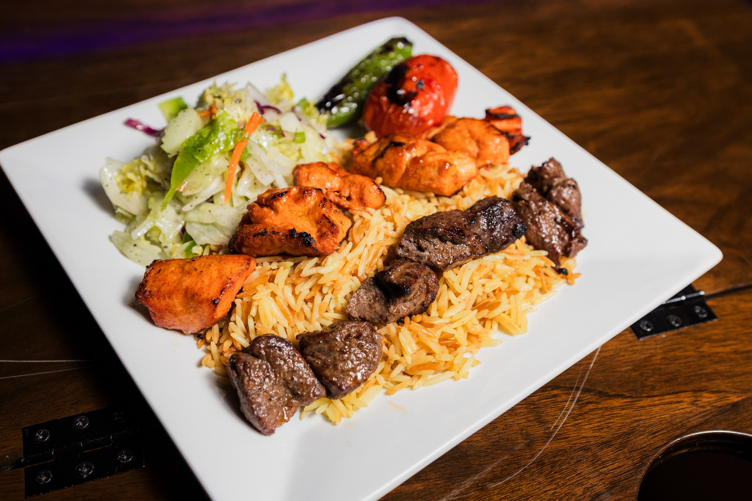 Mix Kabob Skewers Plate of chicken and beef, with sides of rice and salad